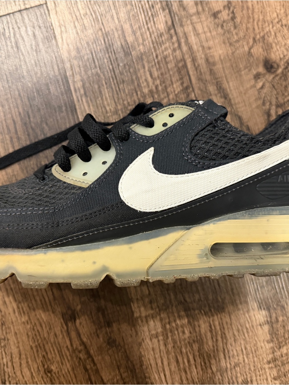 Nike Black Sneaker with White Swoosh and Yellowed Midsole